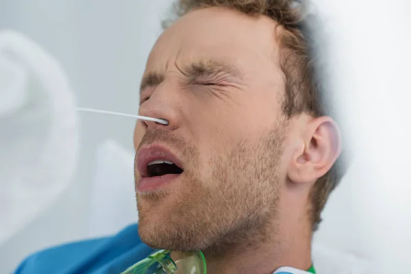 Medico che tiene tampone vicino al naso del paziente durante l'esecuzione del test pcr — Foto stock