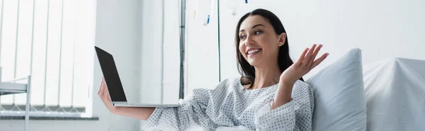 Cheerful woman gesturing during video call in hospital, banner — Stock Photo
