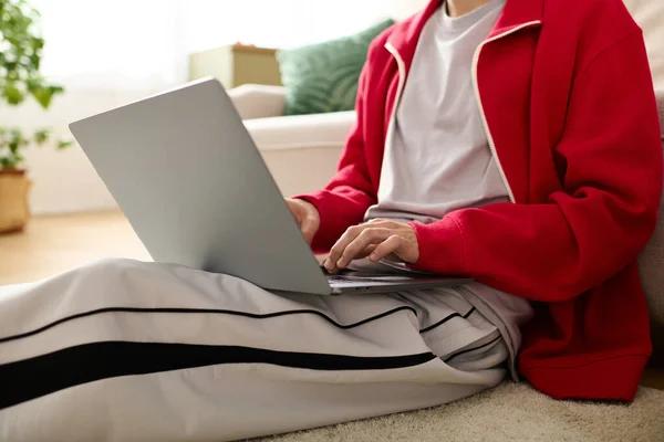 Un homme bien soigné en tenue chic s'assoit confortablement avec un ordinateur portable, concentré sur son travail. — Photo de stock