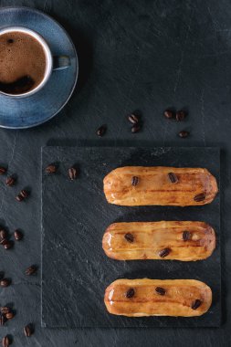 Coffe eclairs with cup of coffee