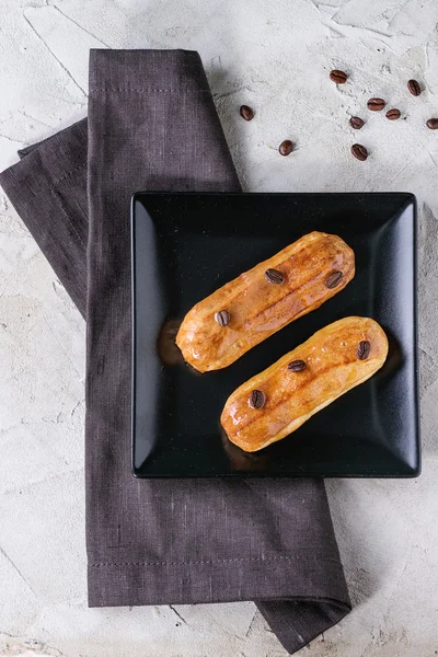 Coffe eclair with coffee beans — 스톡 사진