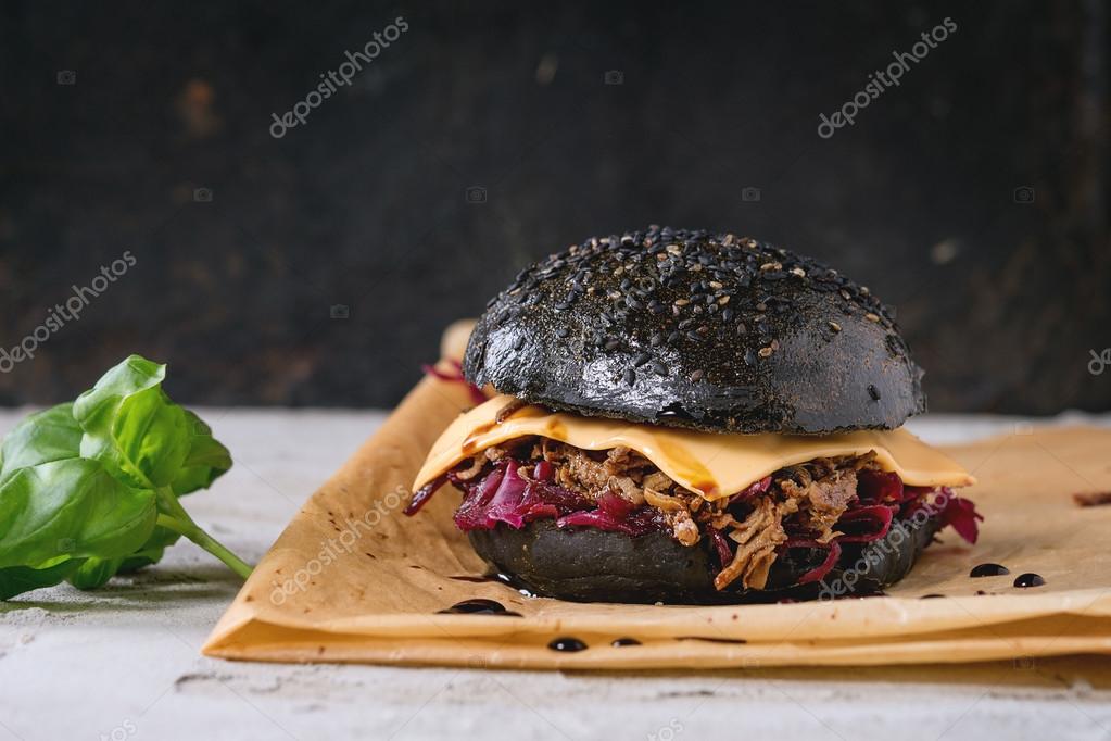 Black burger with stews Stock Photo by ©NatashaBreen 101587772