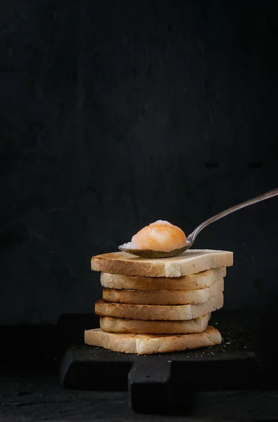 Toasts with yolk over black — Stock Photo, Image