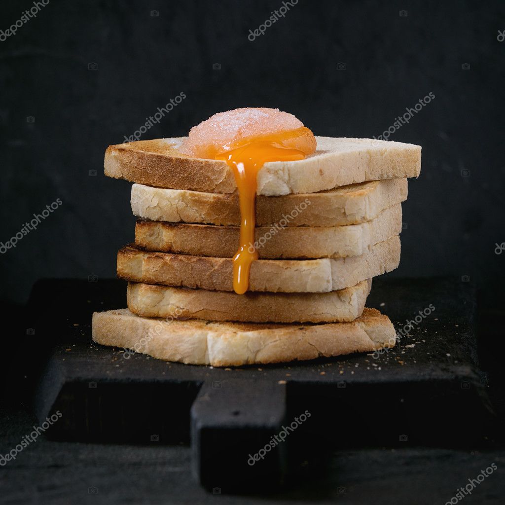 Toasts with yolk over black Stock Photo by ©NatashaBreen 111024106