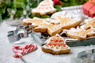 Ev yapımı geleneksel zencefilli kurabiye ve süsleme. Zencefilli adam, melek, beyaz bokeh arka planında xmas süsleri olan çan..