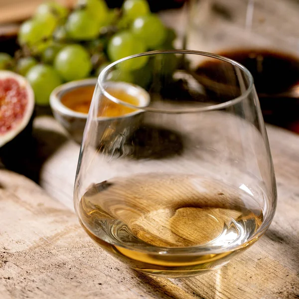 古い木の背景にブドウ イチジク ヤギチーズとクルミと赤と白のワインのグラス 閉めろ — ストック写真