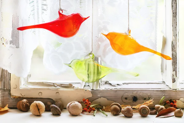 Interior window with glass birds and nuts — Stock Photo, Image