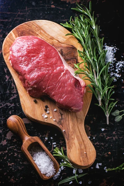 Raw steak with herbs and pepper — Stock Photo, Image