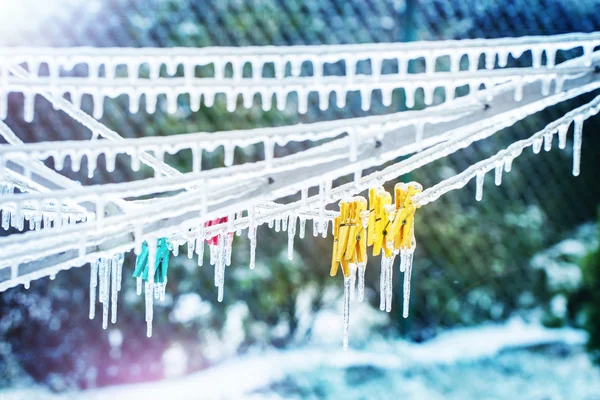 Icicles on clothesline with snow — Stock Photo, Image