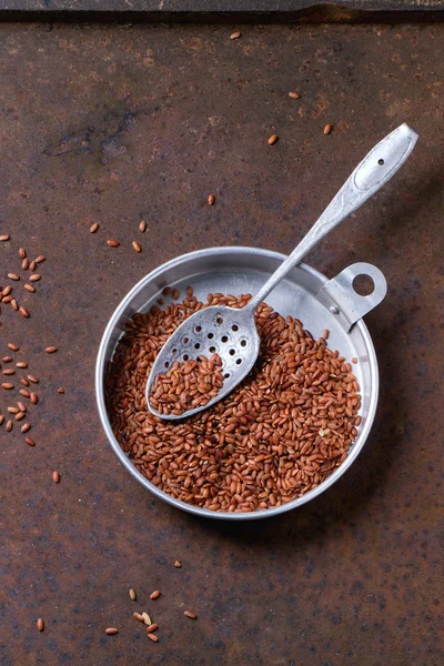 Lino - Linum usitatissimum - semillas en cuchara de madera oscura sobre