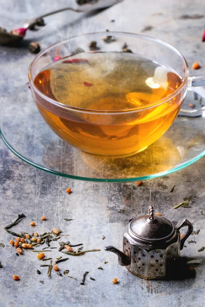 Cup of hot tea with teastrainer — Stock Photo, Image