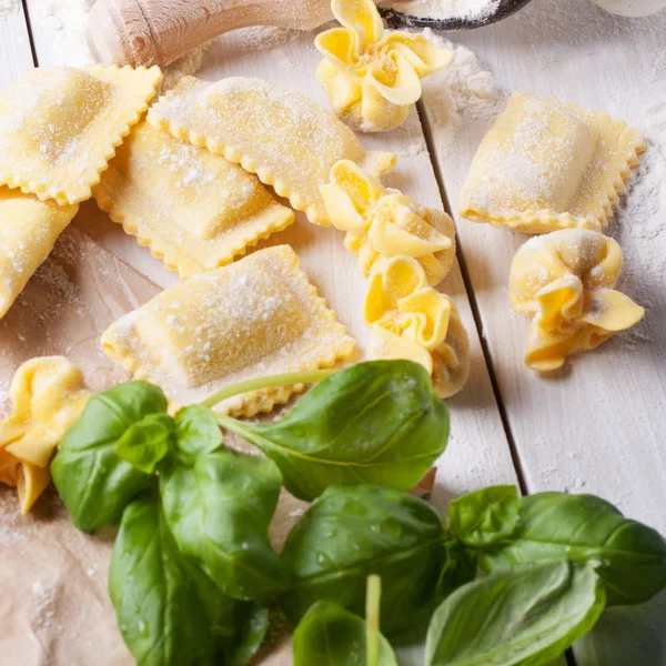 Pasta ravioli on flour with basil — Stock Photo, Image