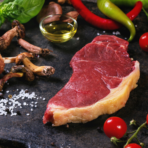 Raw steak with vegetables