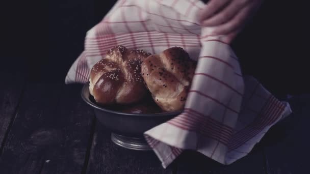 Opening of vintage bowl with fresh baked home made mini challah bread. Dark rustic style. In retro filter effect — Stock Video