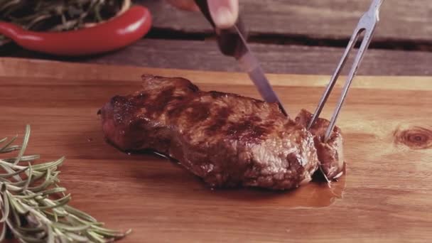 Krájení grilovaný steak na prkně. V retro filtr efekt — Stock video