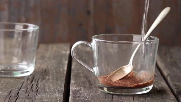 Стеклянная чашка горячего шоколада с винтажной серебряной ложкой поверх старого деревянного стола. Сельский стиль — стоковое видео