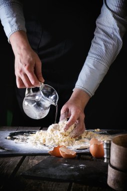 Knead the dough by female hands
