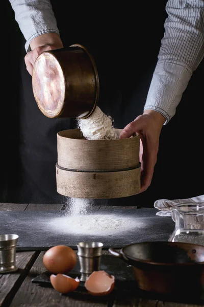 Sifting flour by female hands — Stok fotoğraf