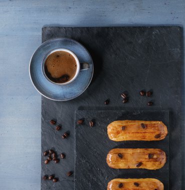 Coffe eclairs with cup of coffee
