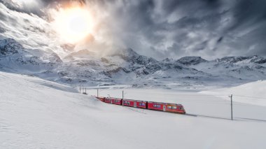 Swiss mountain train Bernina Express crossed through the high mo clipart