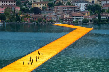 The floating piers. The artist Christo walkway on Lake Iseo. Fir clipart