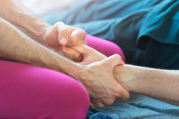 Massager with the finger of the hand stretching — Stock Photo, Image