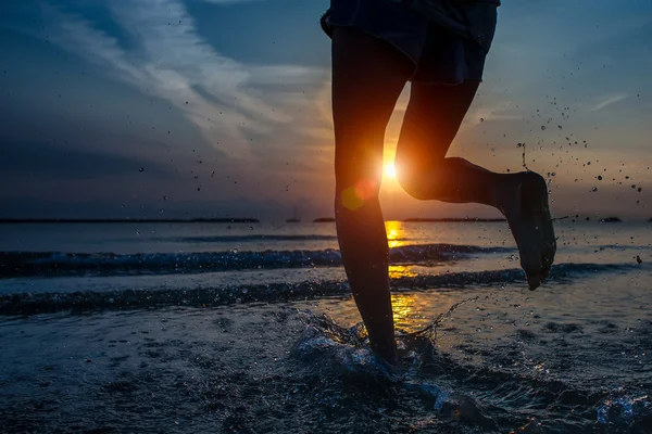 Detail of woman's legs running by the sea — Stock Photo, Image