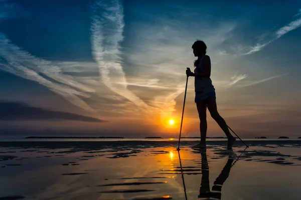 Nordic walking in the beach at sunrise — Stock Photo, Image