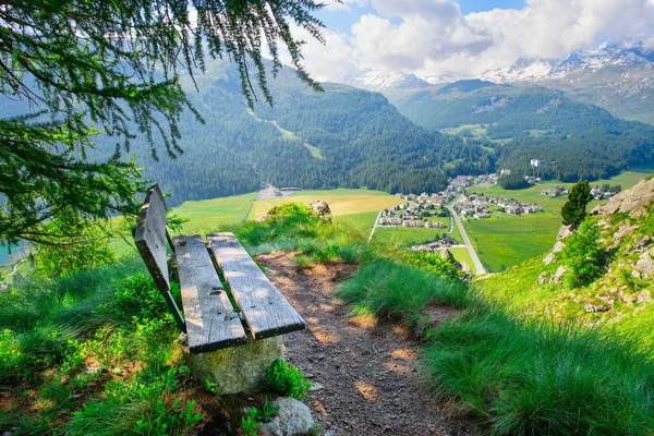 Деревянная скамейка с видом на горный пейзаж — стоковое фото