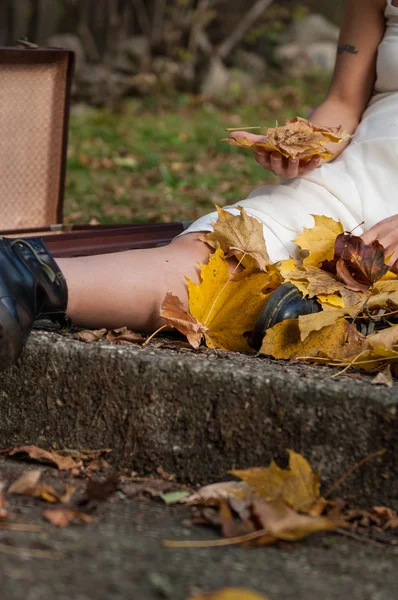 Chica juega con hojas en la temporada de otoño — Foto de Stock