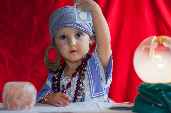 Little child plays to be a fortune teller — Stock Photo, Image