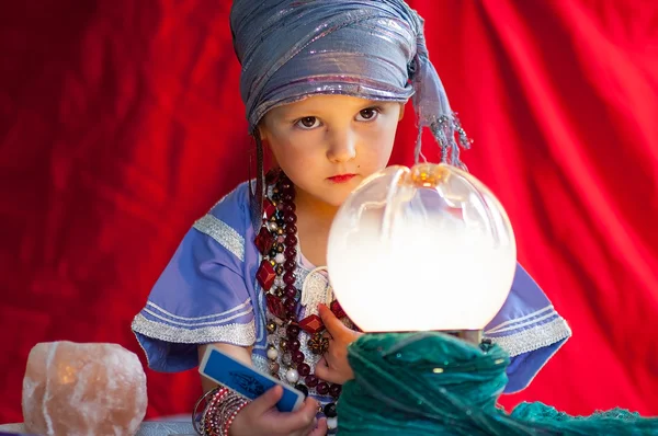 Little child plays to be a fortune teller — Stock Photo, Image