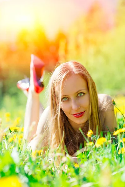 Sensual woman in a flowery meadow — Stock Photo, Image