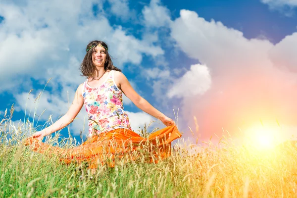 Hippie girl in a spring meadow strong colors — Stock Photo, Image