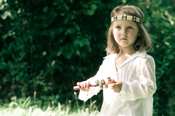 Portrait of hippy child playing rattle  in vintage style in vint — Stock Photo, Image