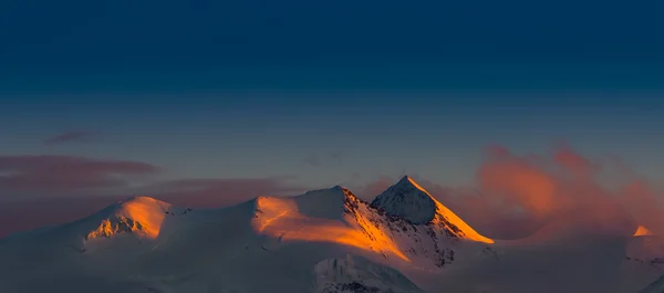 Panorama de montañas de nieve puesta de sol roja —  Fotos de Stock