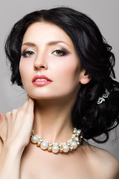 Portrait of beautiful aristocratic woman touching her neck