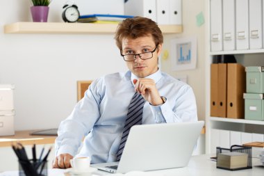 Portrait of bookkeeper or auditor sitting at his workplace clipart