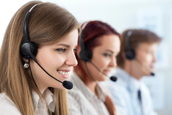 Portrait of call center worker accompanied by her team