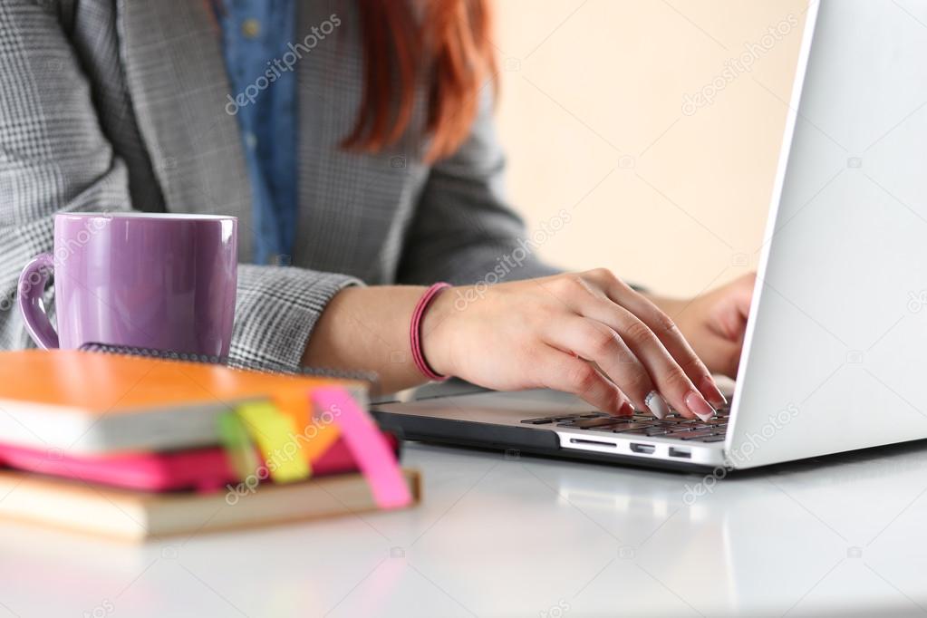 Close up view of businesswoman hands working on laptop