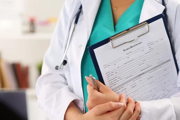 Närbild av kvinnlig läkare händer håller patient registratio — Stockfoto