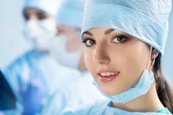 Portrait of happy young female surgeon or intern — Stock Photo, Image