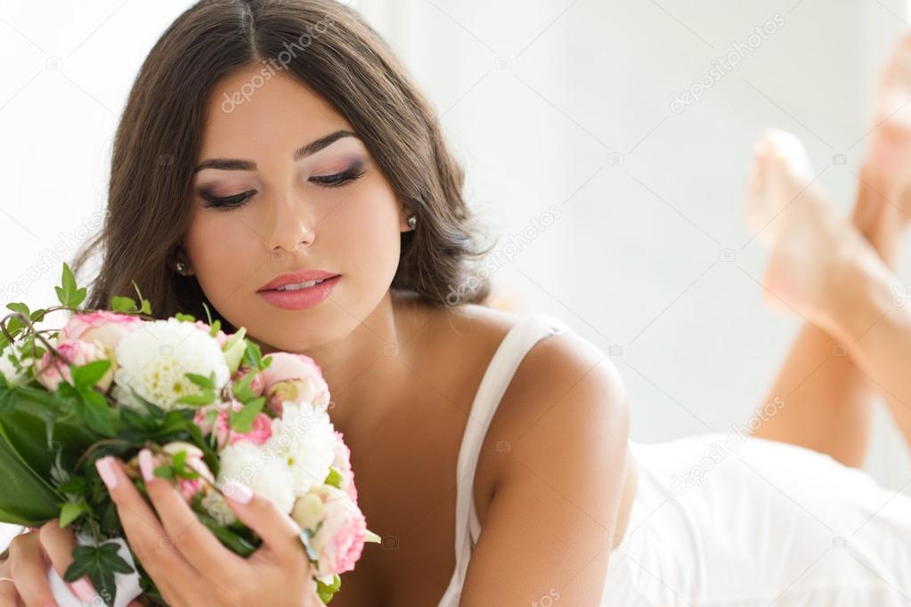 Beautiful bride holding nuptial bouquet