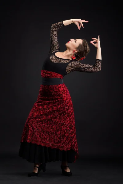 Flamenco dancer in white dress with red earrings over dark background — Stock Photo, Image