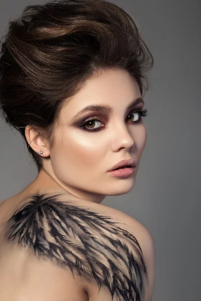 Portrait of young sensual brunette woman with black wing — Stock Photo, Image