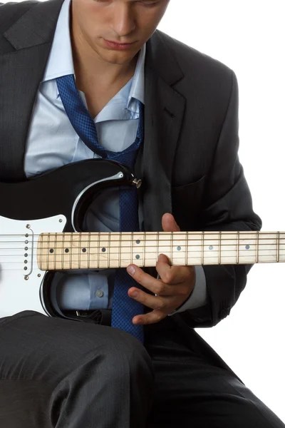 Man in suit and tie playing electric guitar — Stock Photo, Image