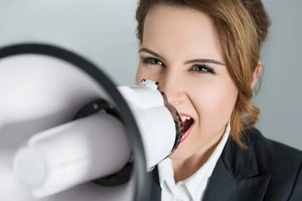 Jovem mulher de negócios gritando com um megafone — Fotografia de Stock