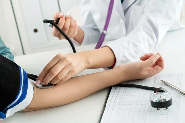 Médica médica que mede a pressão arterial — Fotografia de Stock