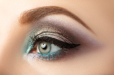 Close-up of woman's eye with creative modern make-up clipart