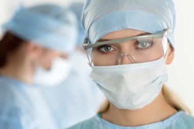 Close-up of surgeon woman looking at camera clipart